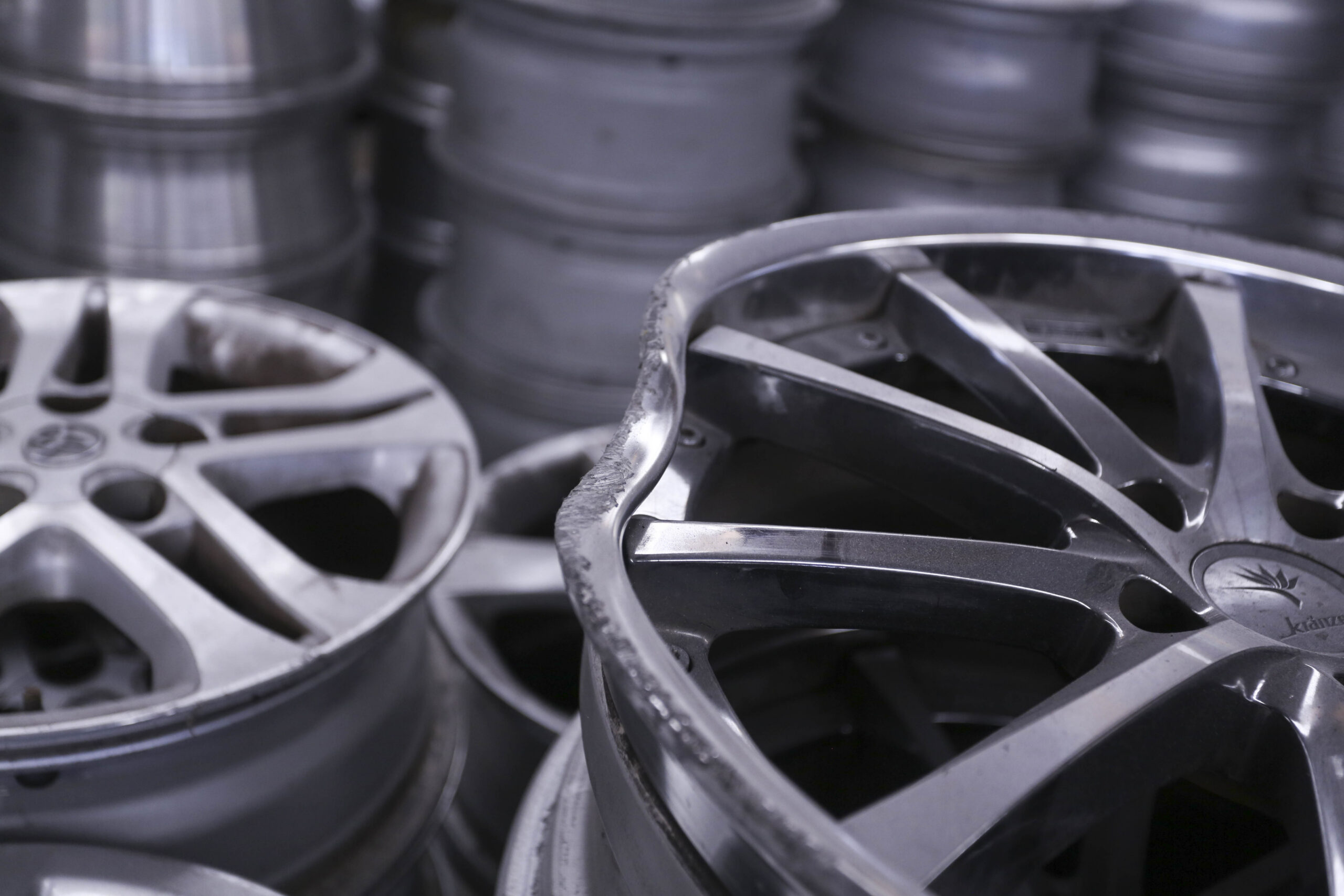 A rack of damaged alloy wheels awaiting repair at the Mag Wheel Guru machine shop
