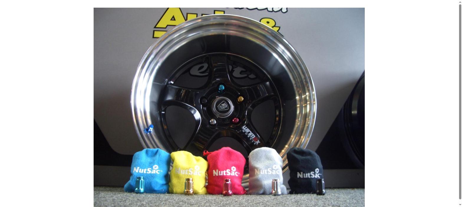 NutSac coloured spline wheel nuts displayed with a chrome mag wheel — Manukau Auto & Tyre Centre